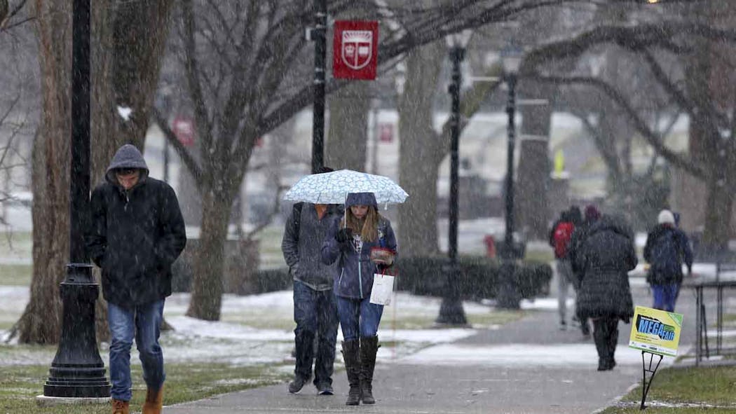 Rutgers University campus with students walking in snow.