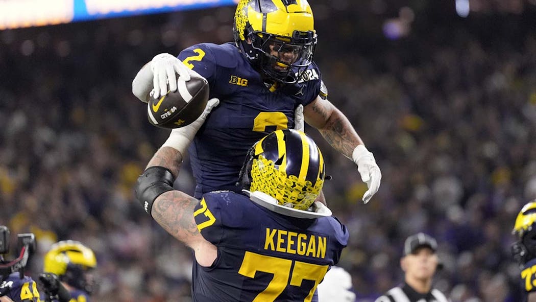 Corum Scores 2 TDs Michigan Overpowers Washington 34 13